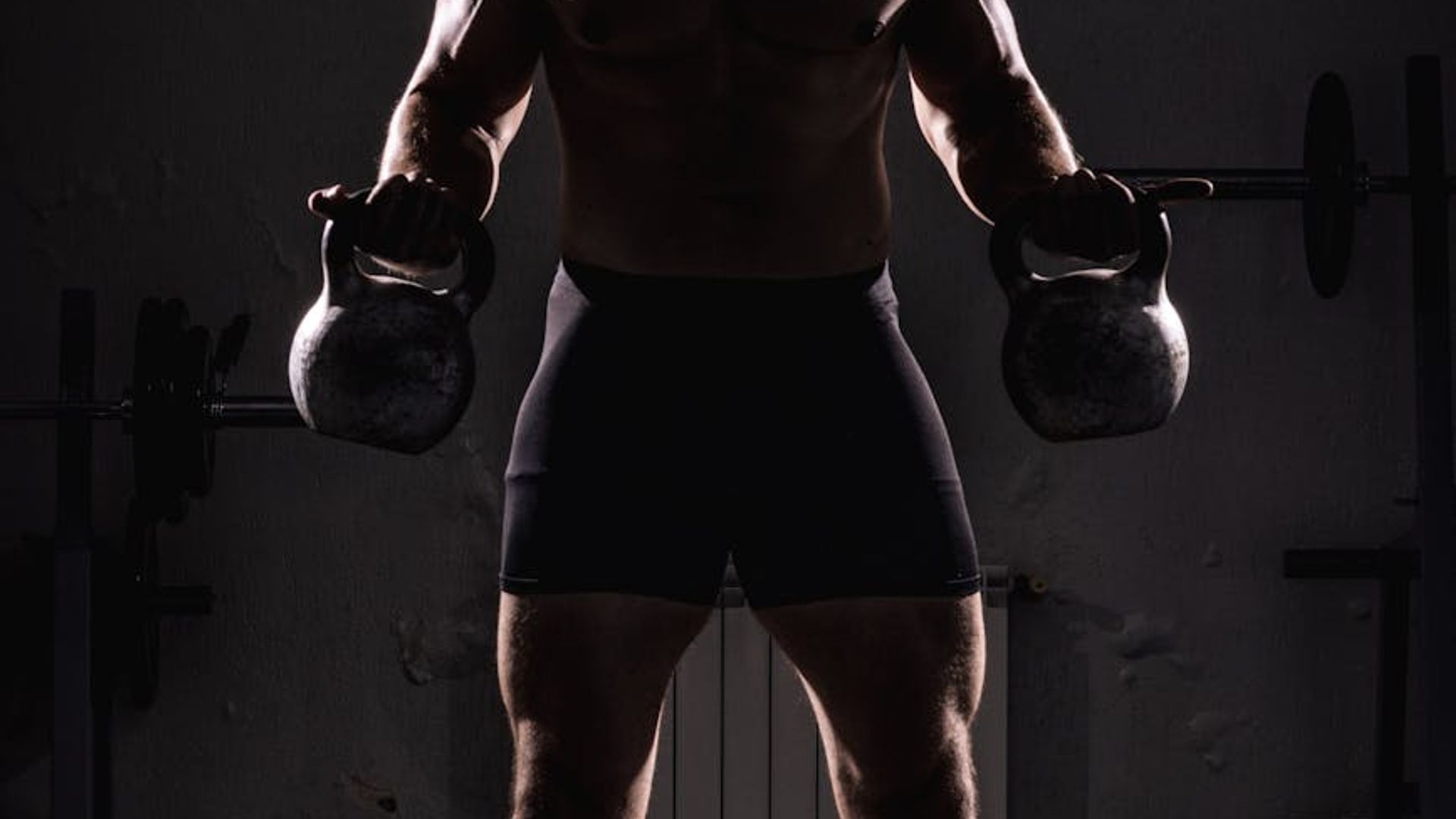 Athletic man focused on strength exercises in a minimalist industrial space