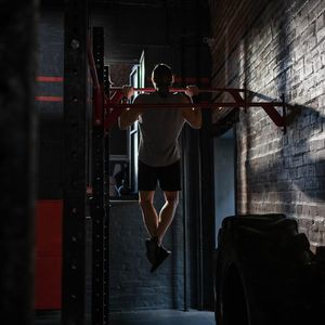 Close-up of a man gripping a steel exercise bar