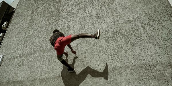 Shadow of an athlete performing a strength movement on wall